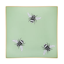 Load image into Gallery viewer, An artisanal, decorative glass valet tray with three bee illustrations on a pale sage green background finished with an 18kt gold leaf edging