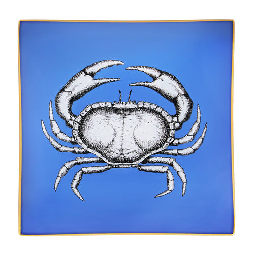 An artisanal, decorative glass valet tray with a crab illustration on a cornflower blue background finished with an 18kt gold leaf edging