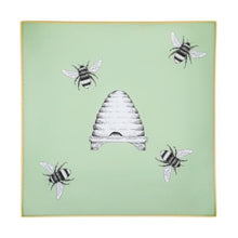 Load image into Gallery viewer, An artisanal, decorative glass valet tray with illustrations of four bees surrounding a bee hive on a pale sage green background finished with an 18kt gold leaf edging
