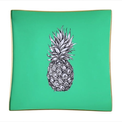 An artisanal, decorative glass valet tray with a pineapple illustration on a mint green background finished with an 18kt gold leaf edging