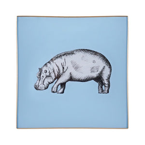 An artisanal, decorative glass valet tray with a hippo illustration on a pale blue background finished with an 18kt gold leaf edging