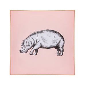 A decorative glass tray with a hippo illustration on a blush pink background finished with an 18kt gold leaf edging