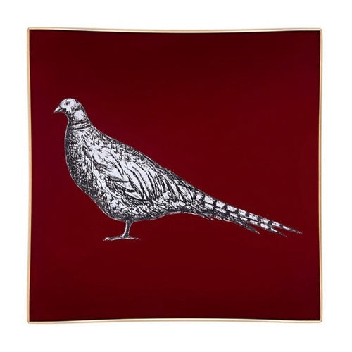 A decorative glass tray with a pheasant illustration on a burgundy background finished with an 18kt gold leaf edging